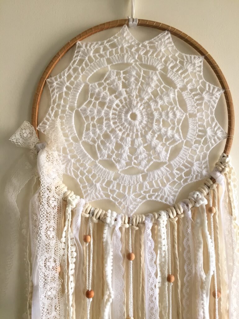 10 Boho Dreamcatcher Ideas to Transform Your Bedroom Décor Your bedroom should feel like a peaceful escape — a place where worries melt away and good vibes enter. That’s exactly why boho dreamcatchers for bedroom décor have become a must-have in modern bohemian interiors. Handcrafted with feathers, beads, macramé, and natural elements, these beautiful pieces don’t just decorate — they add a layer of calm, mysticism, and personality to your space. Dreamcatchers have long been associated with protection and positive energy. Today, they are also loved as artistic décor elements that bring warmth and charm to modern homes. If you love bohemian aesthetics, explore our handcrafted collection to find designs that instantly elevate your bedroom. Explore the collection here: https://homelymess.com/product-category/dreamcatcher/ 1. The Classic Over-Bed Statement Hang a large boho dreamcatcher directly above your bed for an instant statement. Oversized designs with neutral tones, feathers, and wooden beads create a calming and grounded atmosphere. This placement naturally draws attention and makes your bed the centerpiece of the room. Browse similar designs: https://homelymess.com/product-category/dreamcatcher/ 2. Asymmetrical Gallery Wall Cluster Create a beautiful gallery wall by mixing 3–5 dreamcatchers of different sizes. Combining shapes, textures, and colors creates a layered bohemian style that feels artistic and cozy. You can also add small mirrors, dried flowers, or fairy lights to enhance the visual depth of your wall décor. 3. Minimalist Macramé Dreamcatcher If you prefer a modern boho style, choose a minimalist macramé dreamcatcher. Neutral shades like white, beige, or cream create a clean and elegant look. Hang it near a window so natural light highlights the beautiful woven patterns. 4. Rainbow Chakra Inspired Dreamcatcher Add vibrant energy to your bedroom with colorful dreamcatchers inspired by chakra colors. Feathers and beads in bright tones bring positivity and personality to your décor. These designs work especially well in meditation corners or creative spaces. 5. Vintage Lace and Feather Dreamcatcher For a romantic and feminine touch, choose dreamcatchers that combine vintage lace with soft flowing feathers. This style pairs beautifully with pastel bedroom palettes like blush pink, ivory, or soft lavender. 6. Shelf or Headboard Accent Smaller dreamcatchers can be used as decorative accents around your bedroom. You can style them on: Floating shelves Near indoor plants Beside candles Along the headboard Layering different décor pieces together creates a cozy and inviting atmosphere. 7. Window Sun-Catcher Effect Hang dreamcatchers near a sunny window so light passes through the feathers, beads, and threads. The sunlight creates soft reflections and shadows that add a magical and calming ambiance to your bedroom. 8. Boho Canopy Integration Attach a dreamcatcher to a bed canopy or drape it with sheer curtains. Combine it with soft string lights to create a dreamy bohemian retreat that feels warm and relaxing. 9. Kid-Friendly or Teen Boho Style Dreamcatchers are also perfect for children’s or teen bedrooms. Choose playful designs with pom-poms, colorful threads, and fun charms. They add a whimsical decorative touch while still maintaining the calming essence dreamcatchers are known for. 10. Seasonal Dreamcatcher Refresh Refresh your dreamcatchers throughout the year by adding seasonal elements. For example: Autumn – dried leaves and warm tones Spring – flowers and pastel colors Summer – shells and light fabrics Winter – crystals or silver accents This keeps your décor feeling fresh and personalized all year round. Final Thoughts Adding even one boho dreamcatcher to your bedroom décor can transform the entire mood of your space. These handcrafted pieces blend cultural symbolism with modern style, making them both meaningful and beautiful. Whether you prefer minimalist designs, colorful accents, or layered gallery walls, dreamcatchers bring warmth and creativity to any bedroom. Discover handcrafted dreamcatchers that perfectly match your style: Handcrafted boho dreamcatcher hanging above bed in cozy bedroom